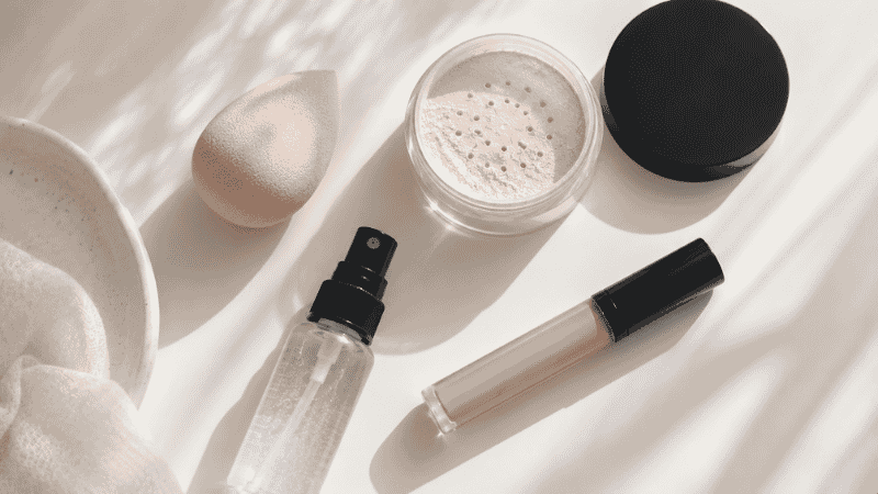 Makeup tools to fix common beginner mistakes — beauty sponge, setting powder, and setting spray