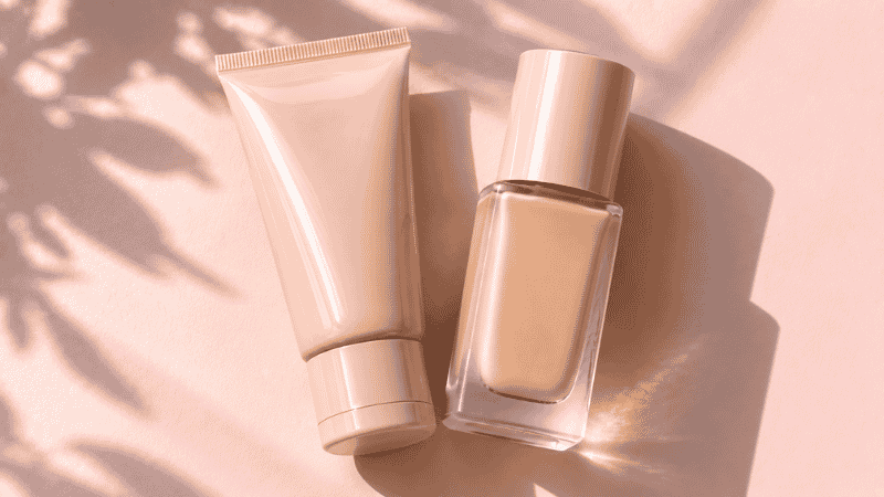 Tinted moisturizer tube and foundation bottle placed side by side for a beginner product comparison
