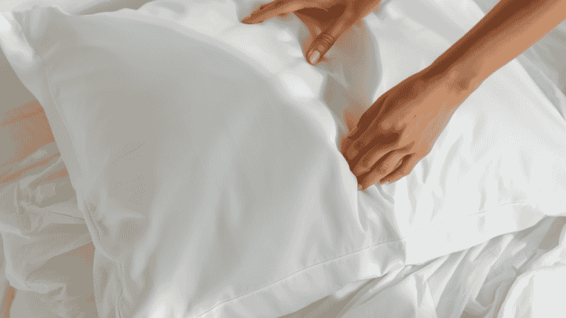Fresh clean white pillowcase being changed weekly as a practical tip for preventing acne breakouts
