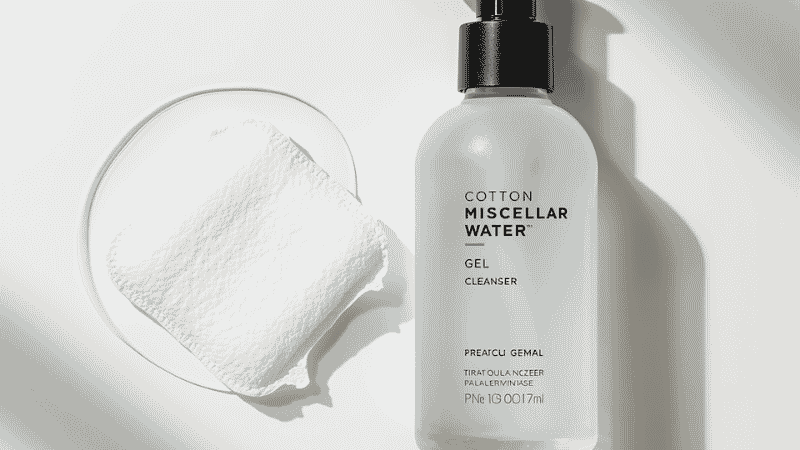 Micellar water on cotton pad followed by gel cleanser showing the double cleanse method for acne-prone skin