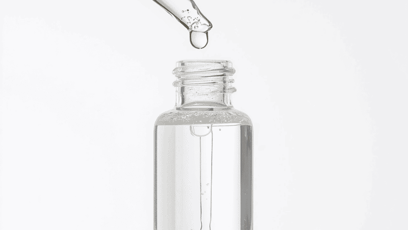 Niacinamide serum dropper bottle with one drop falling showing lightweight clear formula for oily skin