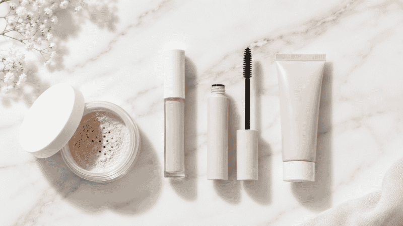 Gentle fragrance-free makeup products for sensitive skin including mineral foundation concealer and mascara on white surface