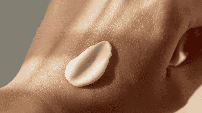 Close-up macro shot of a creamy, whipped natural face moisturizer texture, showing the richness of biotech-fermented ceramides for skin barrier repair.