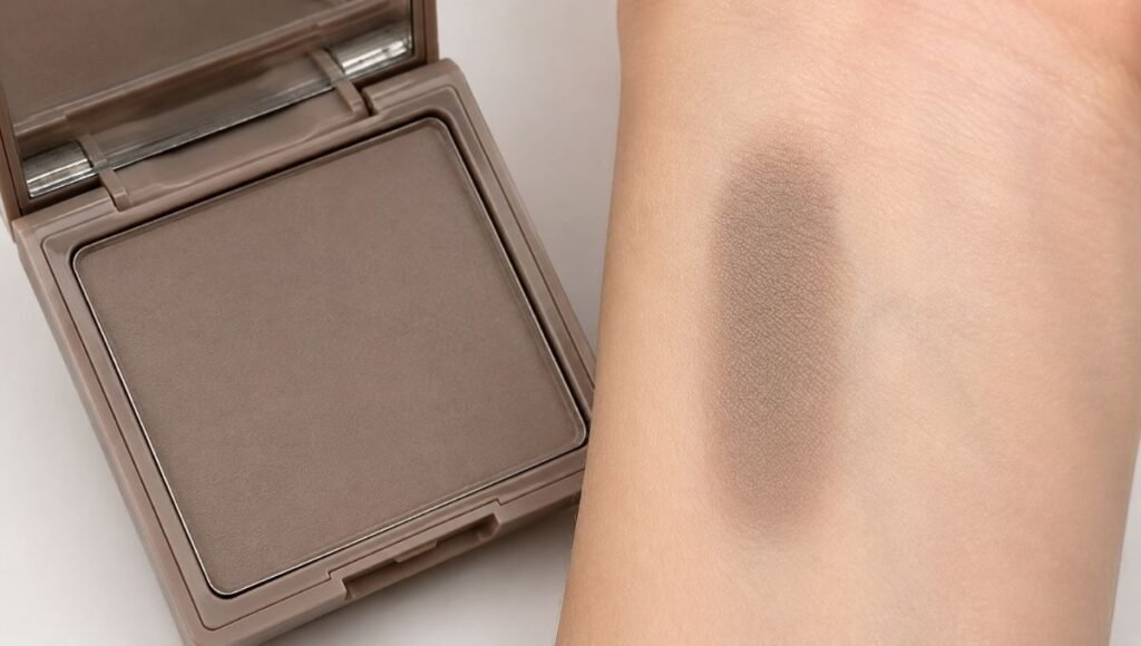 Cool-toned taupe contour powder in a compact showing the correct grey-brown shade for natural face sculpting